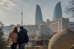 Парень и девушка фотографируют пламенные башни Баку. Азербайджан.